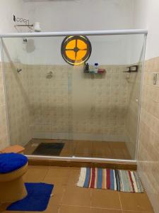 een douche met een glazen deur in de badkamer bij Casa Temporada Cabo Frio in São Pedro da Aldeia