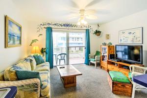 a living room with a couch and a tv at Balcony and Ocean Views Central Ocean City Condo in Ocean City