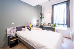 a person laying on a bed in a bedroom at Résidence Kley Angers in Angers