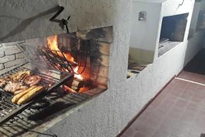 a brick oven with food cooking in it at Apartamento en Península con vista a las Islas 1 Dorm y Estar in Punta del Este