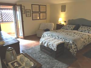 a bedroom with a bed and a couch and a table at LA CORTE DEL MULINO 1725 in San Salvatore Telesino +64 photos