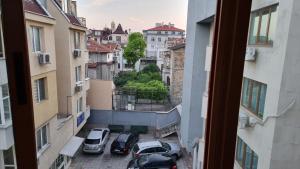 a view from a window of a parking lot with cars at Coffee Apartment in Varna City