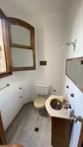 a bathroom with a toilet and a sink at La San Francisco III in Salta