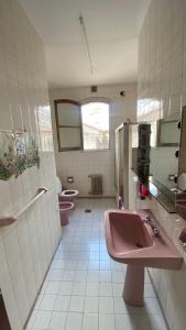 łazienka z 2 różowymi umywalkami i 2 toaletami w obiekcie La San Francisco III w mieście Salta