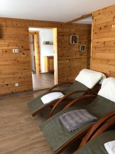 a room with wooden walls and wooden floors and chairs at Glätzle`s Ferienhaus in Zöblen