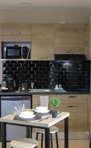 a kitchen with a table with two white plates on it at Résidence "Le Vélodrome" in Maubeuge