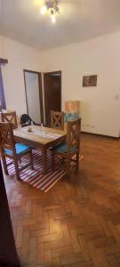 a dining room with a wooden table and chairs at La San Francisco III in Salta