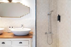 a bathroom with a sink and a shower at Villa Los Flamencos by Veaco- Beachfront & pool in Corralejo