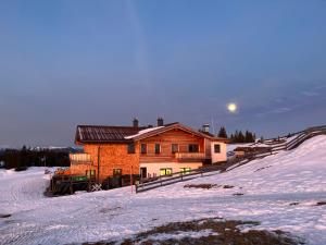 a house on top of a snow covered hill at Radstädter Hütte Im Winter nicht mit dem Auto erreichbar Wunderschöne Alleinlage in Schwemmberg