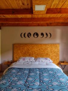 a bedroom with a bed with a wooden head board at Casa Pircas in El Chalten