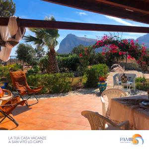 a patio with chairs and a view of a mountain at Pamir Casa Vacanze Villetta in San Vito lo Capo