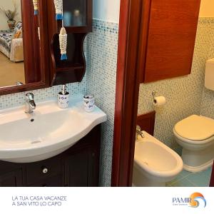 a bathroom with a sink and a toilet at Pamir Casa Vacanze Villetta in San Vito lo Capo