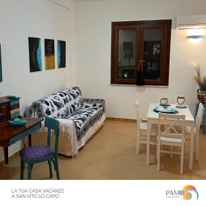 a living room with a couch and a table at Pamir Casa Vacanze Villetta in San Vito lo Capo