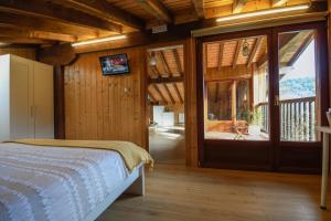 a bedroom with a bed and a sliding glass door at Artesoro Baserria in San Pedro de Galdames