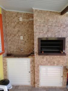 two white garage doors in a brick wall at Pousada Cabral in São Gabriel