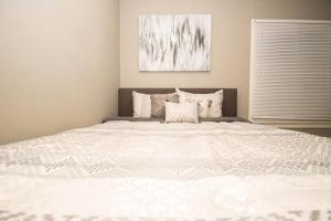 a large white bed in a room with a window at Home Sweet Home Bungalow in North Little Rock
