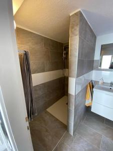 a small bathroom with a sink and a shower at Casa Siepelunga in Villmar