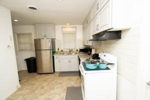 a kitchen with white cabinets and a stainless steel refrigerator at Midtown Serenity in Little Rock in Little Rock