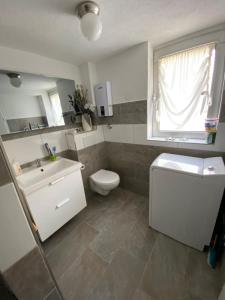 a bathroom with a sink and a toilet and a window at Casa Siepelunga in Villmar +31 photos