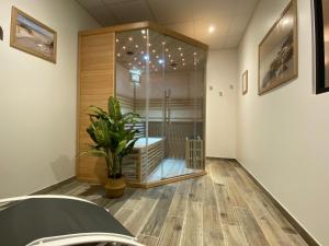 a room with a glass door with a plant in it at La villa perchée in Saint-Prix