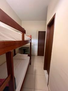 a small room with two bunk beds and a hallway at Rio 222 Hostel in Rio de Janeiro
