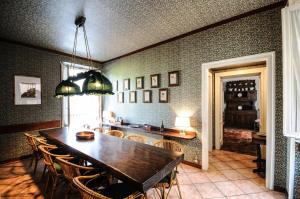 a dining room with a wooden table and chairs at CASA VASCONI CERNOBBIO in Cernobbio
