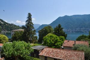 a view of a town with mountains and a lake at CASA VASCONI CERNOBBIO in Cernobbio