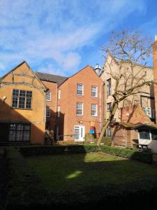 a large brick building with a tree in the yard at 1 Castle Yard in Coventry