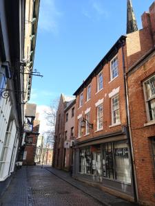 an empty street in an old city with buildings at 1 Castle Yard in Coventry