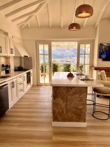 a kitchen with a large island in the middle at Victorias Villas in Villa de Leyva