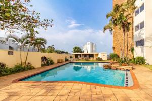 a swimming pool in front of a building at Sea Lodge Umhlanga Rocks in Durban
