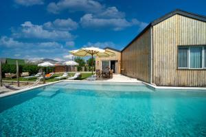 a swimming pool in front of a building at Jaden Farm House in Fethiye