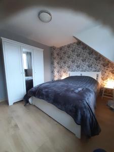 ein Schlafzimmer mit einem großen Bett im Dachgeschoss in der Unterkunft Our Lily House, een gezellig familiehuis in rustige omgeving in Brügge