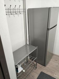 a kitchen with a stainless steel refrigerator in a room at Kub A - 15min de Toplita in Sărmaş