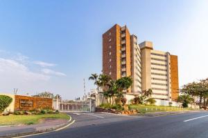 an empty street in front of a large building at Sea Lodge Umhlanga Rocks in Durban