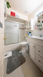 a white bathroom with a toilet and a sink at Booking.Com Exxlusive: Fully Furnished One Bedroom Entire Apartment With Full Size Bed. For One Person Or Couple, Soulmate Positive Friendship in Brooklyn