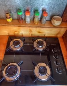 a stove top with four burners on top of it at Casa Pircas in El Chalten