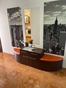 a bathroom with a vanity with a view of a city at Urokliwy Apartament w Nowym Sączu in Nowy Sącz
