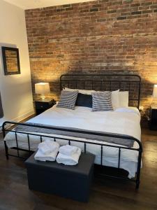 a bedroom with a large bed with a brick wall at M11Upscale 1BR Sofabed in heart PlateauMile-end in Montréal