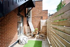 a small patio with two chairs and a table at M11Upscale 1BR Sofabed in heart PlateauMile-end in Montreal