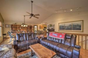 a living room with leather furniture and a ceiling fan at Decks and Scenic Views Beech Mountain Cabin! in Beech Mountain