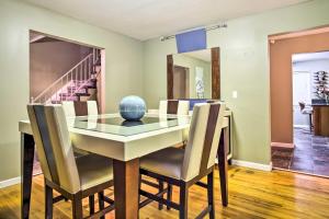 a dining room with a glass table and chairs at Suburban Detroit Home with Porch, Yard and Fire Pit! in Southfield