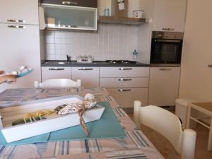 a kitchen with a table with a box on it at Tana della Volpe in Arbus