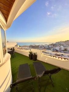 a balcony with a chair and a view of the ocean at Duplex Sea View by Albufeira Holidays in Albufeira