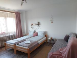 a small bedroom with a bed and a couch at Scala Soba in Bačka Topola