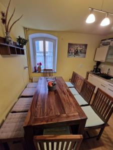 a large wooden table in a kitchen with chairs at Ferienhaus Heideck in Heideck