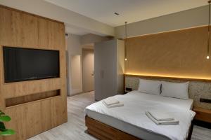 a bedroom with a bed and a flat screen tv at 21 Rooms Hotel in Istanbul