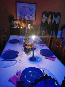 a table with plates and glasses and a candle on it at Spacious Villa in Dilbeek with Private Garden, Ideal for Families & Business in Dilbeek