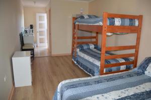 a room with three bunk beds and a hallway at Apartamentos Turista in Osorno