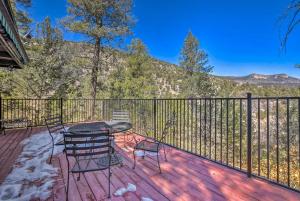 a patio with a table and chairs on a deck at Unique Cabin with Mtn Views-Steps to the Jemez River! in Jemez Springs